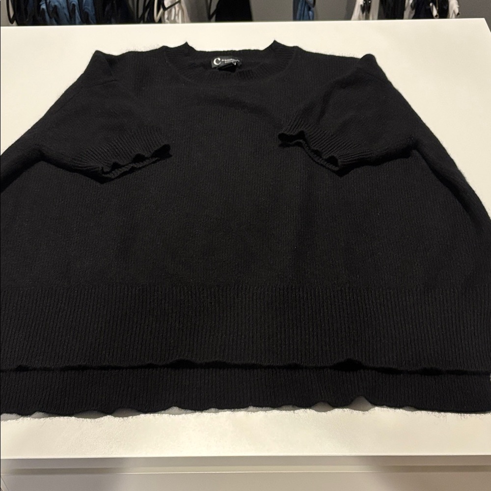 Short sleeve crew neck cashmere sweater. Longer in back. Fuller fit sweater